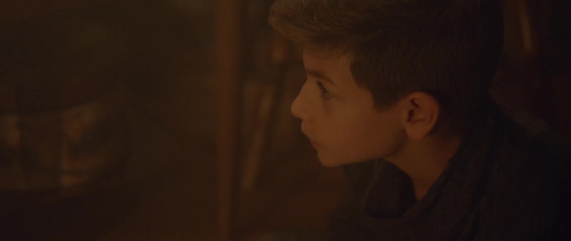 A boy slowly looks up