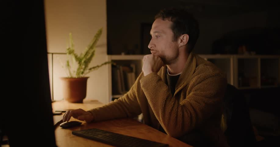 A man sitting in a room using a computer