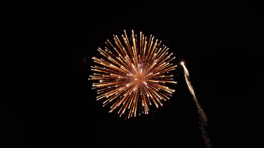 A shot of a firework going into the air and going off