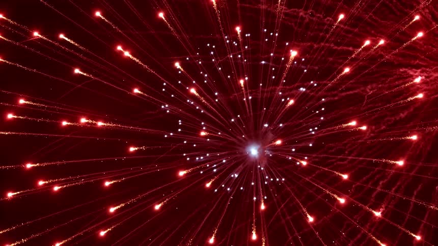 Bright colorful fireworks explode and burst in the night sky