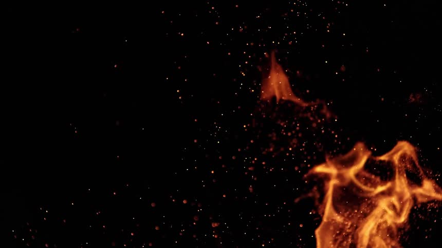 A view of flames burning outdoors at night
