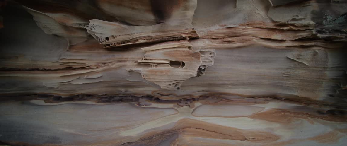 Striations and layers in tan white and orange
