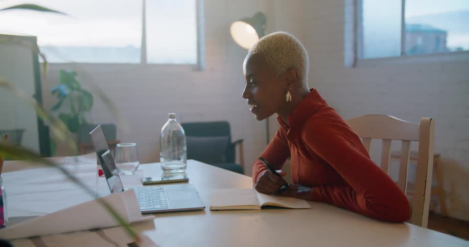 A woman using a laptop in a room