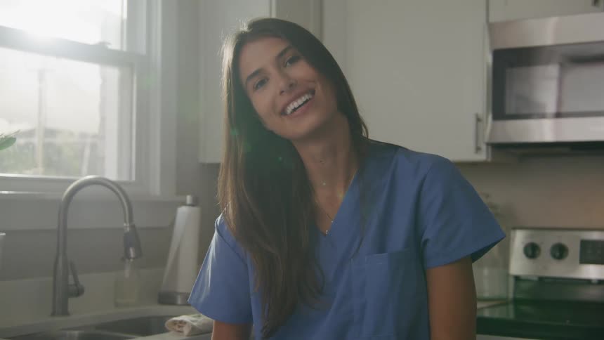 A woman smiling standing in a kitchen