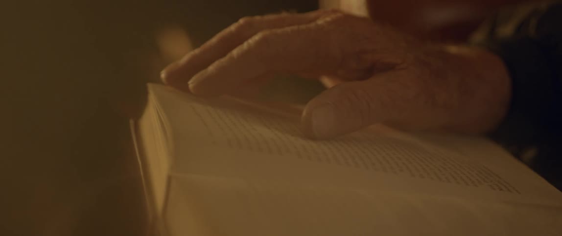 A hand is tracing words in a book