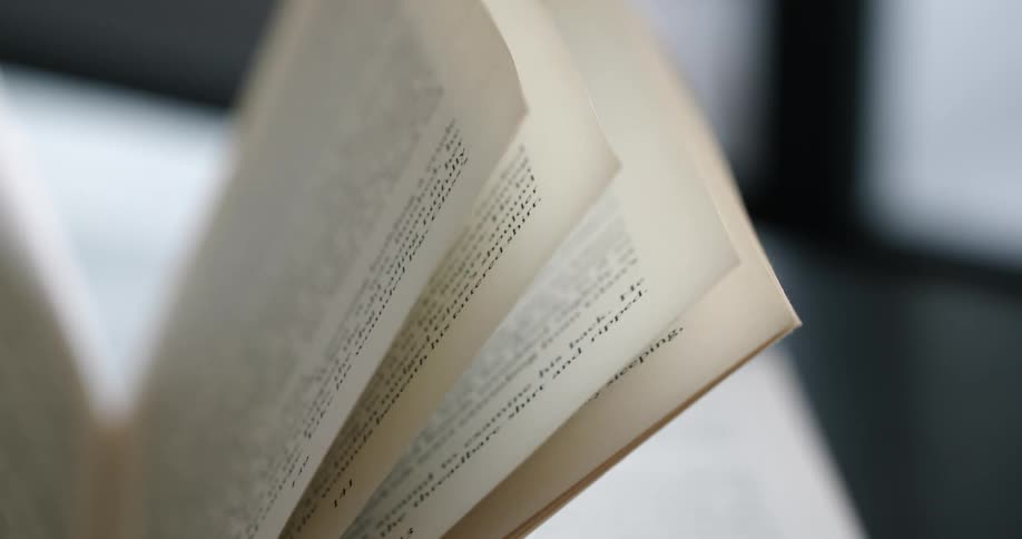 Pages of an open book wave and move