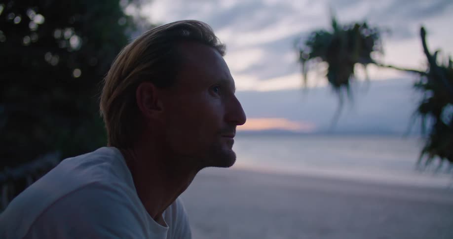 A man sitting at the beach thinking