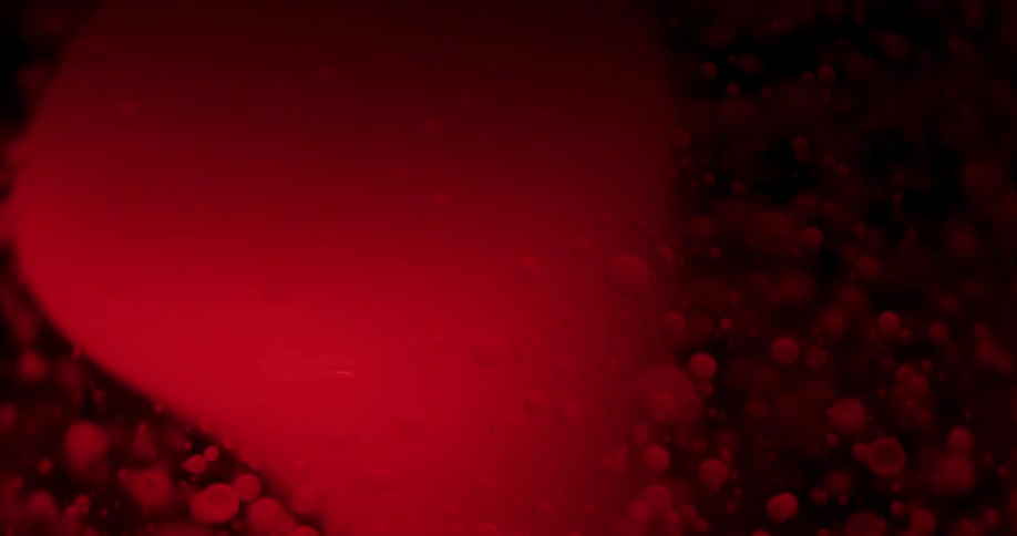 A close up of a large carbonation bubbles with many small bubbles