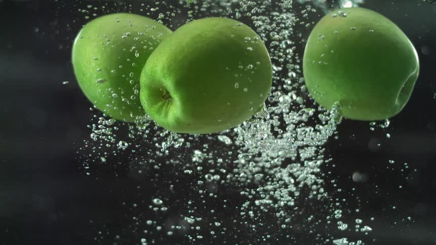 Three apples floating back up to the surface