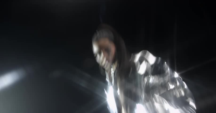 A model is moving around posing on a stage