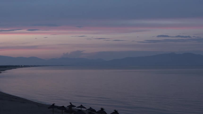 A purple and blue sky hangs over a body of water
