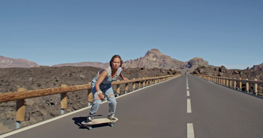 A woman skateboarding outdoors
