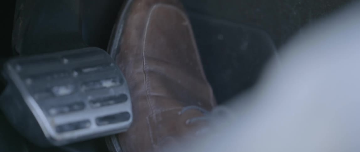 Close up of a foot pressing the gas on a car