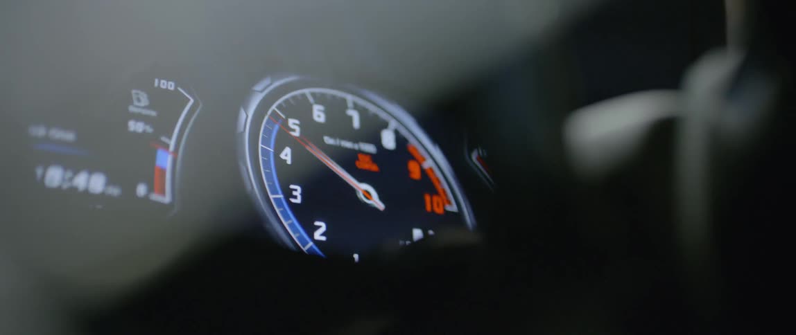 A gauge in a vehicle changes as an engine is revved