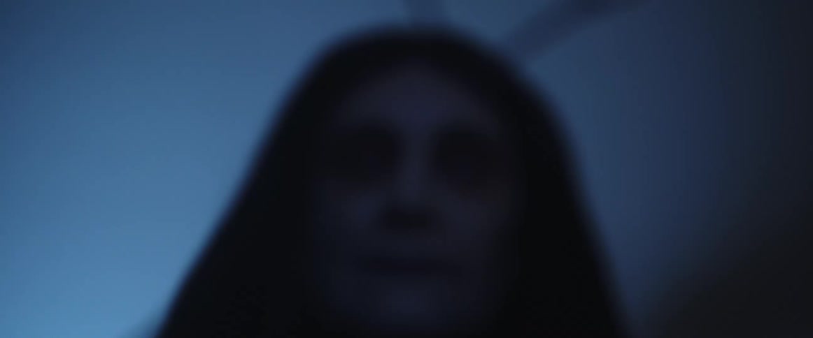 Close up of the brigh eerie eyes of a long haired woman