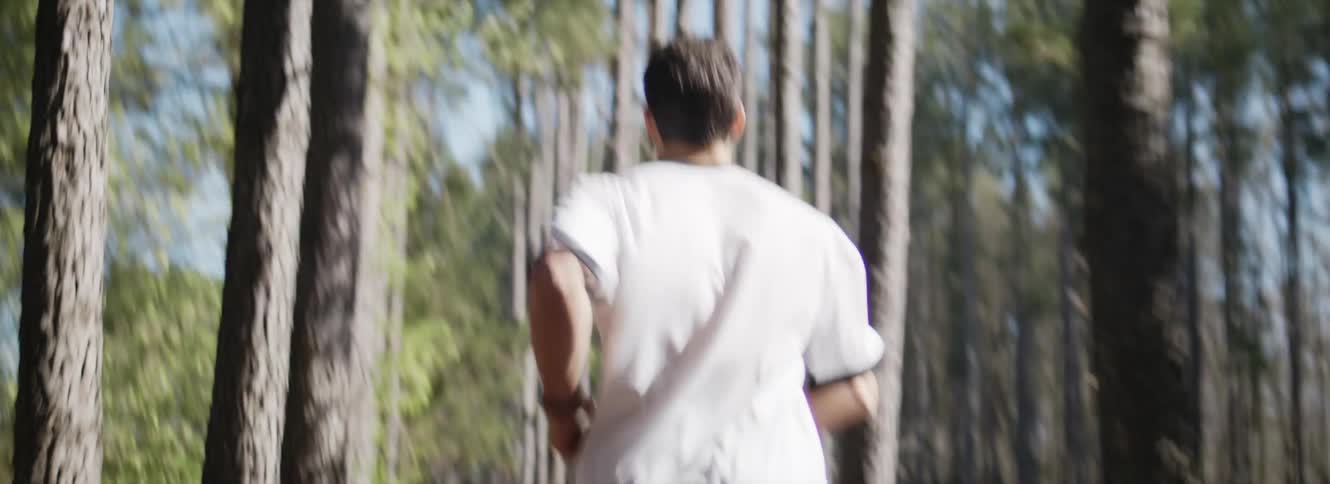 A man is running through the forest