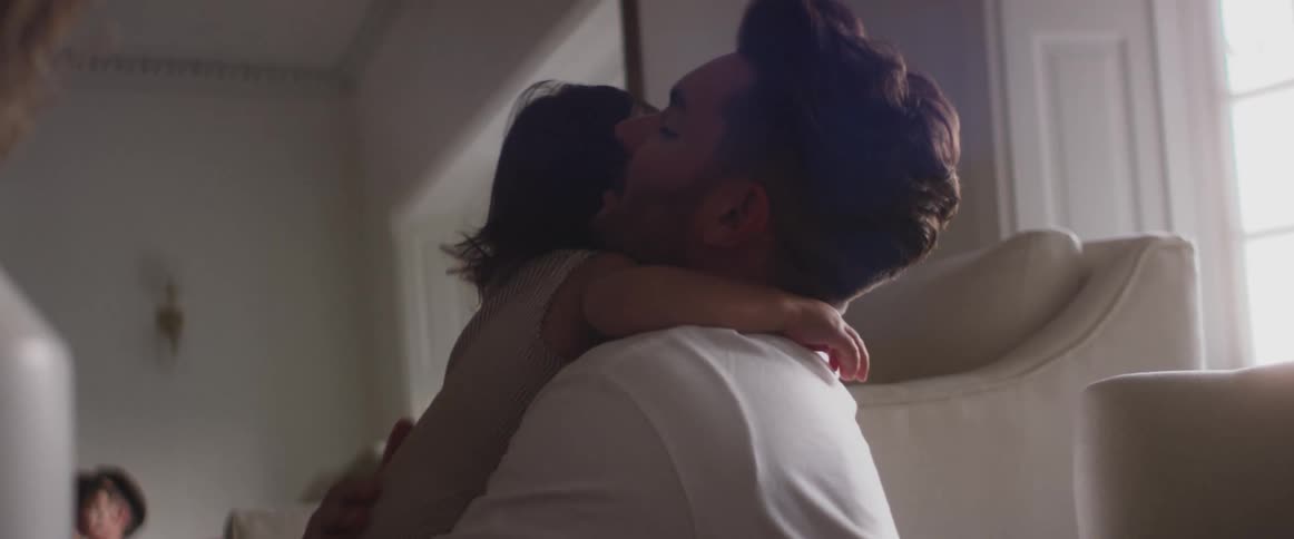 A father hugs  his child in the living room