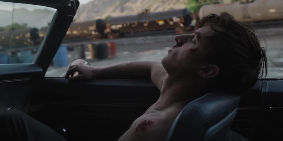 A man is riding in the passenger seat of a vehicle with his eyes closed