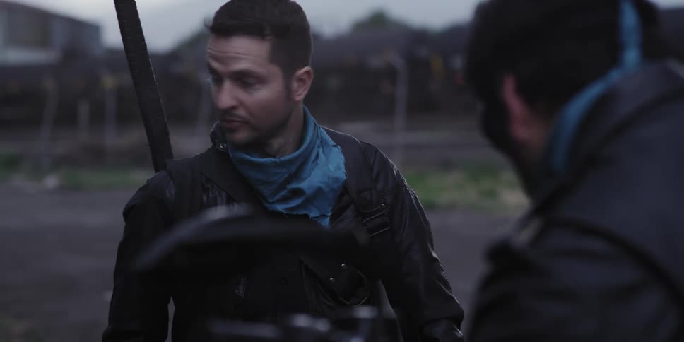 A man is outside talking to his friend