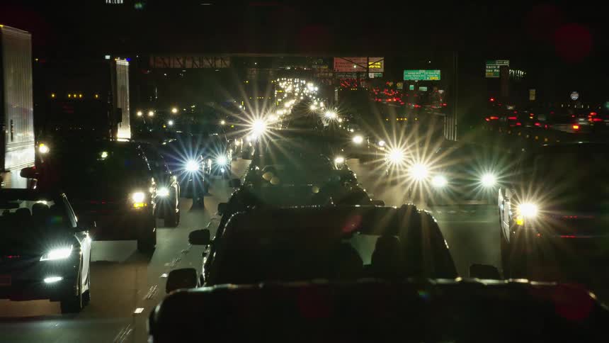 Time lapse of dense rush hour traffic at night near a large city