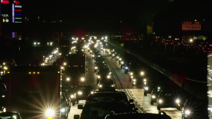 Time lapse of the headlights of cars moving on the highway at night