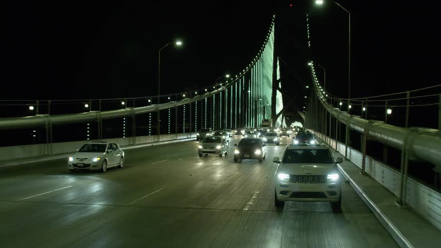 Heavy traffic crossing a bridge at night