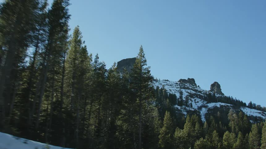 Traveling on a forest mountain road on a winter day
