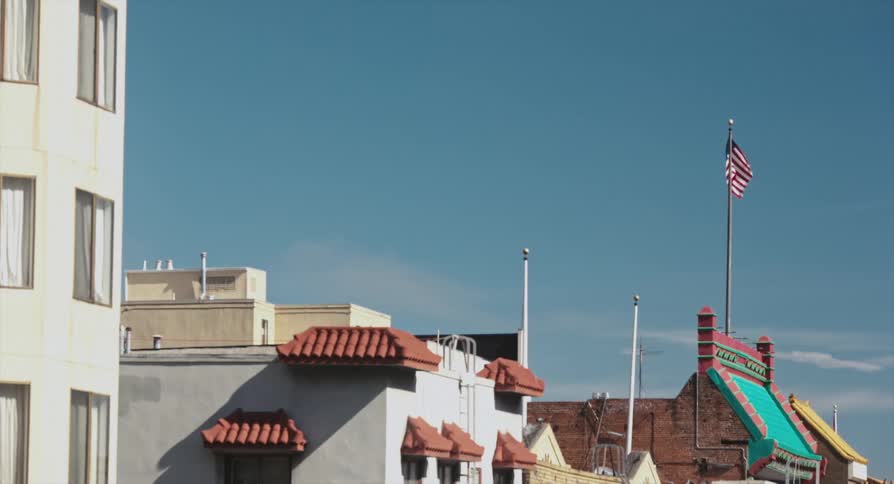 The top of a few buildings with the sky in the background