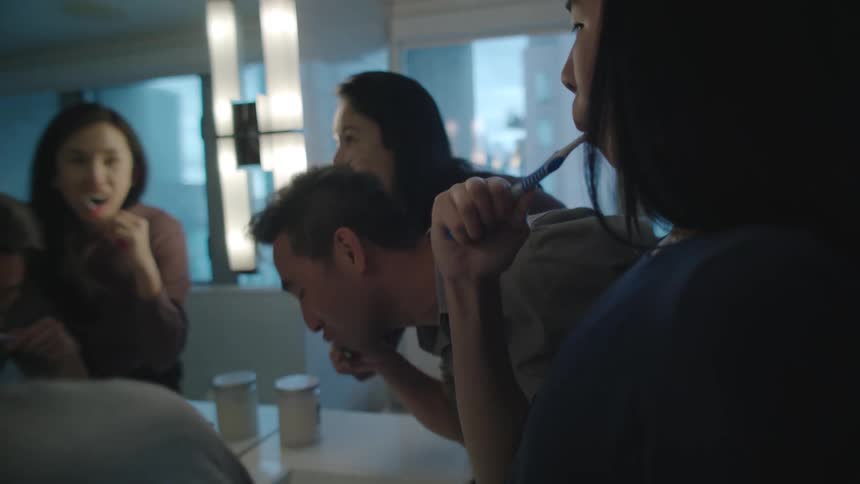 Family brushing their teeth toghether in the batroom at home