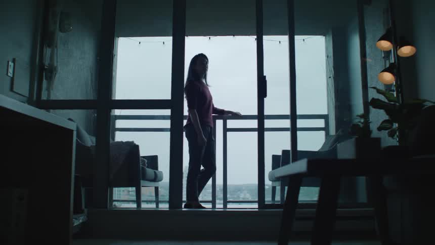 Female standing on balcony