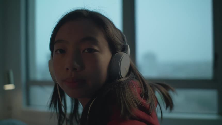 A girl is wearing headphones