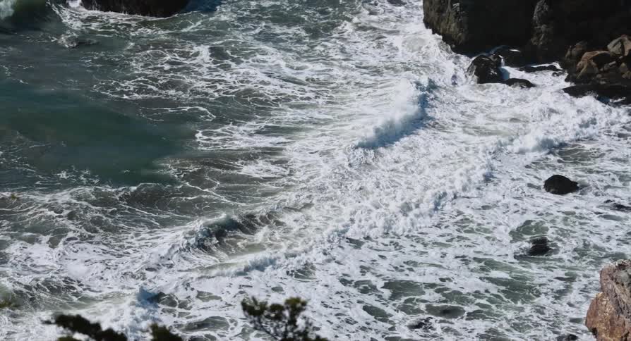 Frothy waves roll onto a rocky beach
