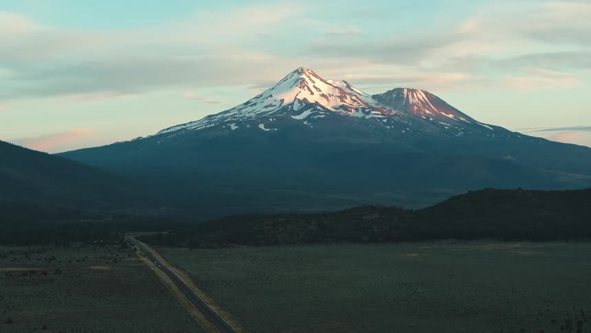 Mountains with snow covered peaks under a cloudy sky
