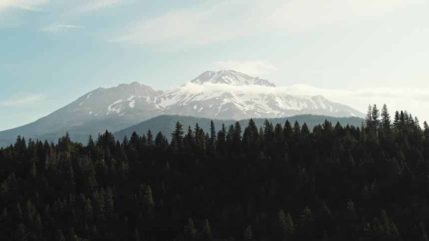 Aerial view of high mountains with forest silhouette