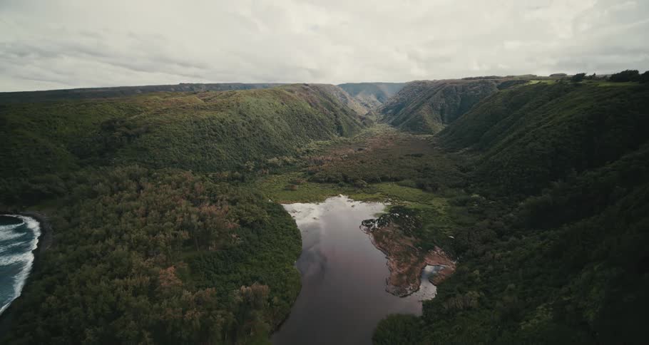 The river runs by the shore through the mountains