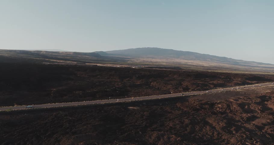 Aerial view of vehicles driving on highway on the open plains