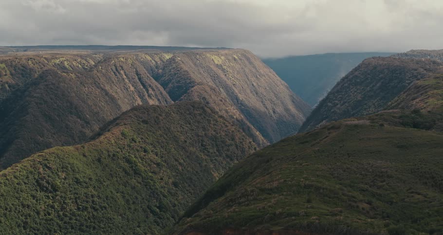 Fog covers valley between plateaus under overcast sky