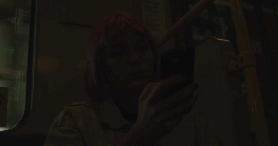 A woman using a smart phone on public transit