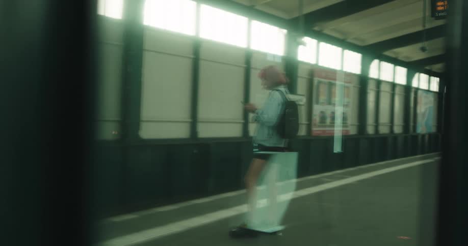 A woman standing and waiting for a train