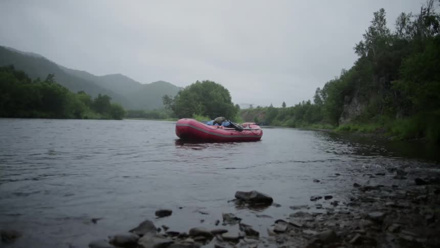 Water rushes past a docked raft