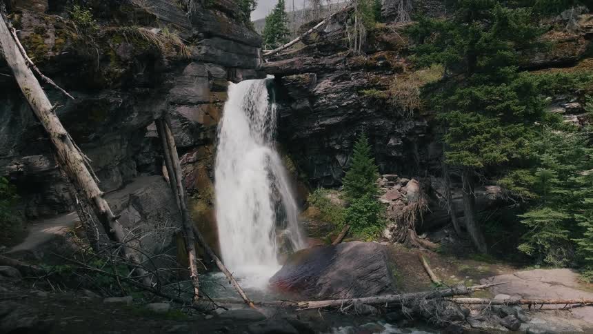 Serene alpine waterfall flowing over rocks