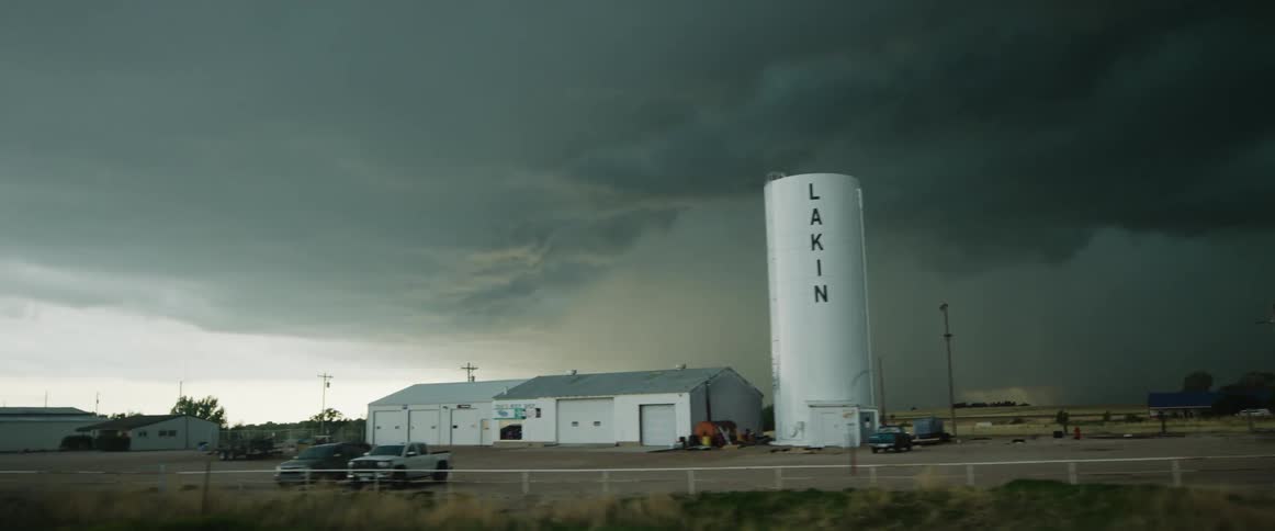 A heavy storm is pouring rain in the distance