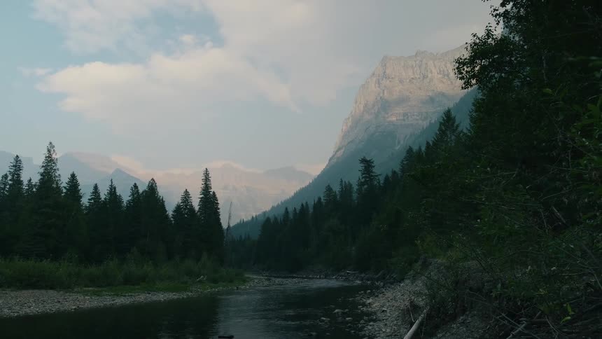Calm river flowing through mountain range