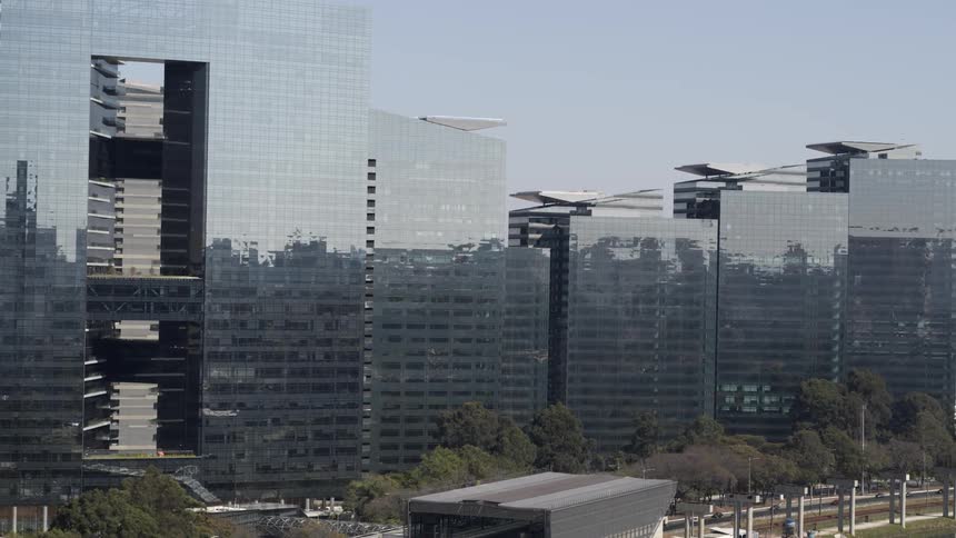 Aerial view of highly reflective office towers in the downtown area of a metropolis during the day