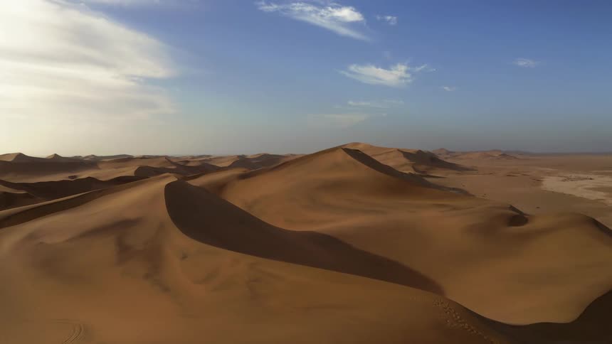 Aerial view of tall sand dunes in the desert at daytime