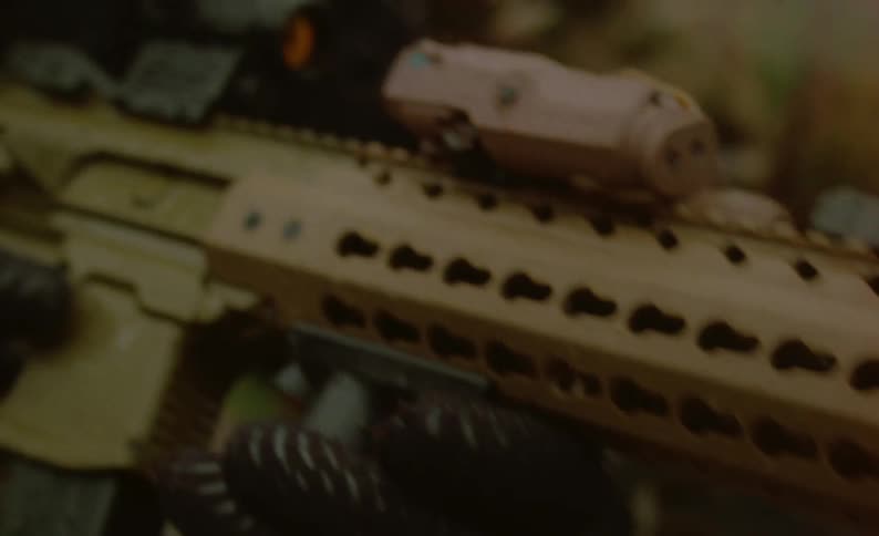 A soldier pointing a gun into the distance