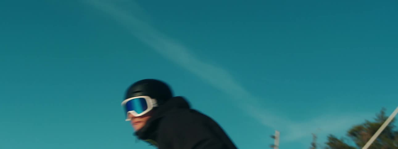 A man rides a snowboard down a mountain