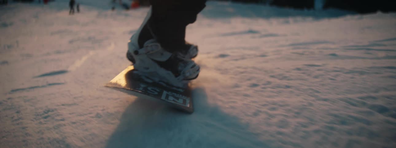 A person is snowboarding down the slope
