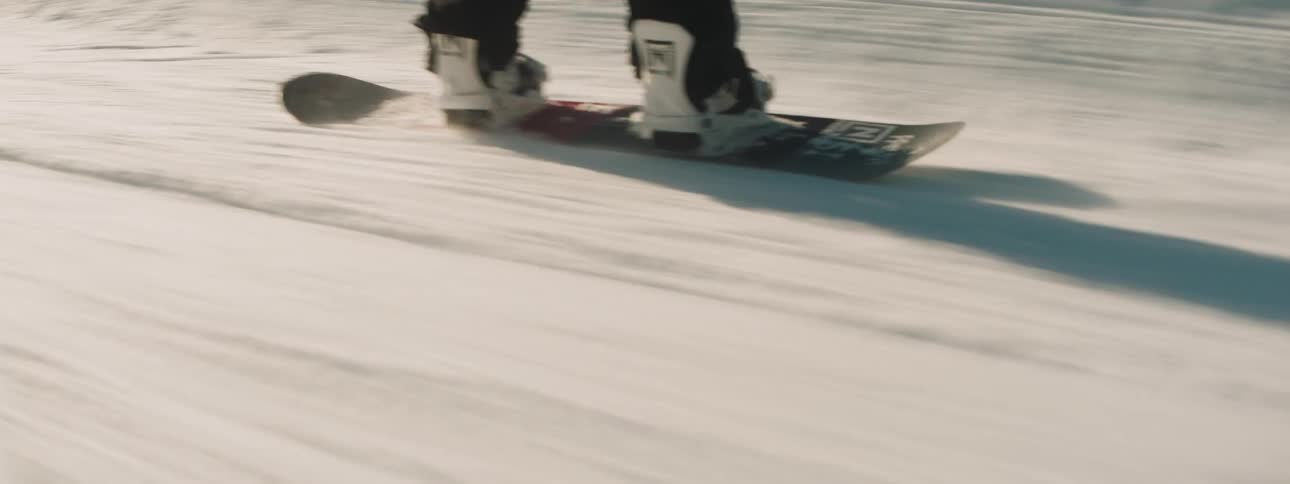 A man snowboards down the slope