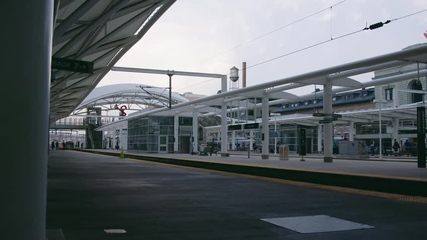 Train stops for people to get on and off at the train station